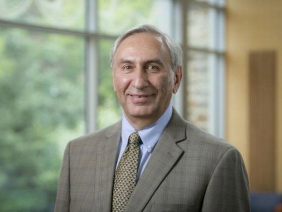 Michael Rubinstein stands in front of a glass window